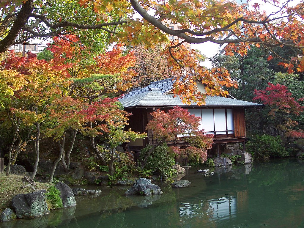 Japan (Kobe- Sorakuen Garden) Beautiful teahouse in garden surrounded with Autumn colored trees